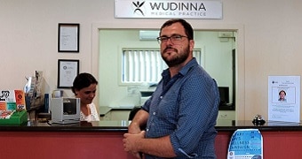 A doctor at a reception desk