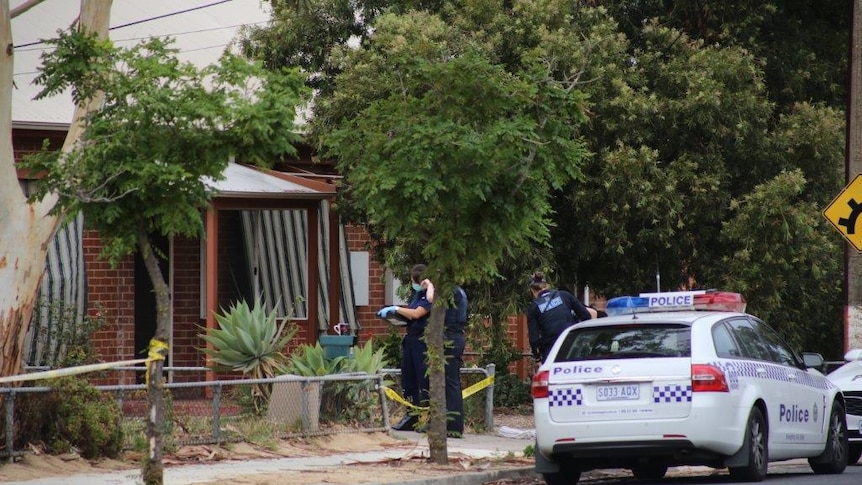 Police outside a home at Kilburn where a 61-year-old woman was fatally stabbed.
