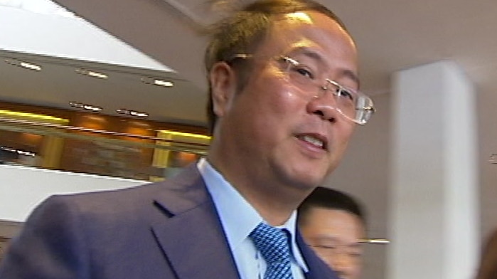 man in suit and glasses walking