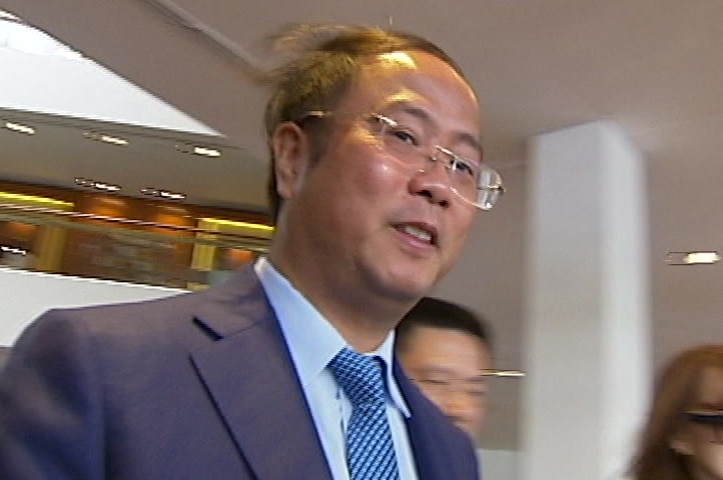 man in suit and glasses walking