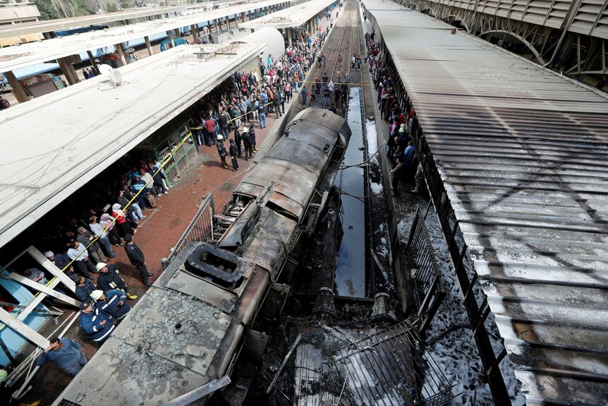 A damaged train is seen at the main train station after a fire caused deaths and injuries.