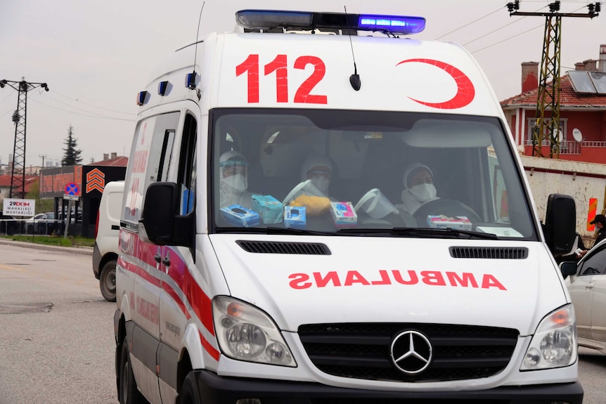 Medical officials sit in an ambulance with released sick prisoners in Sincan outside Ankara, Turkey.