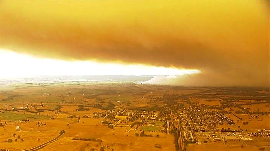 A plume of smoke rises from a bushfire in Gippsland.