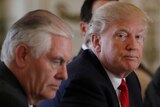 US President Donald Trump sitting next to Secretary of State Rex Tillerson in 2017.