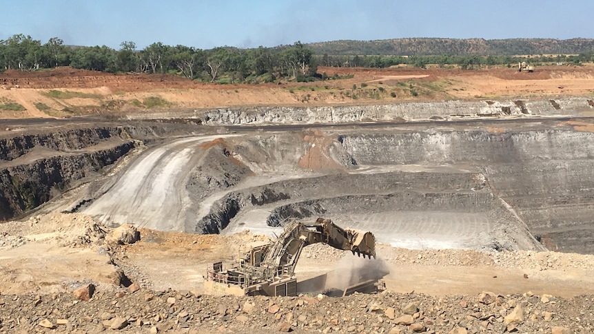 A digger in front of an open pit at the McArthur River Mine.