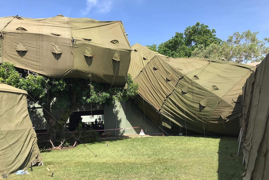 Green tents are on a roof