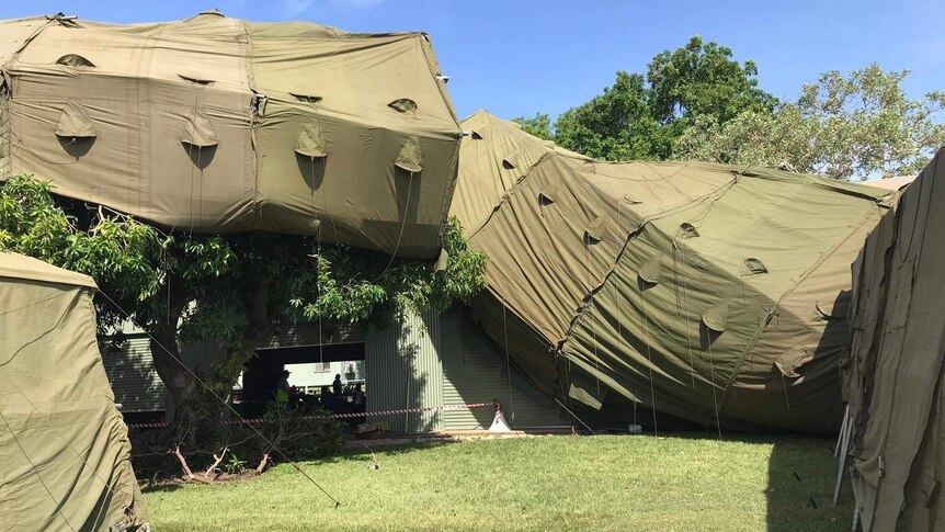 Green tents are on a roof