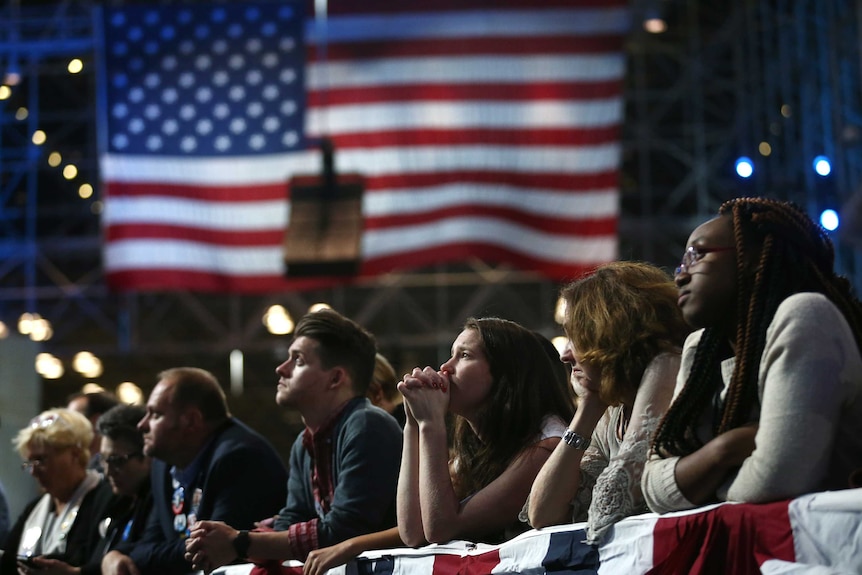 Supporters of Democratic presidential nominee Hillary Clinton watch and wait at her election night rally