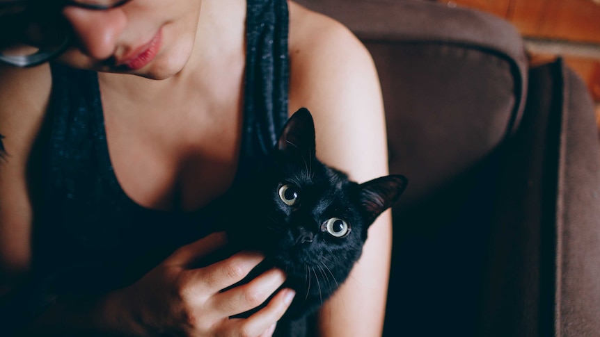 Woman holds cat in her arms