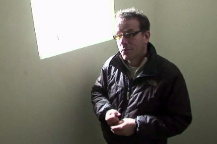 TV still of forensic expert inside Lima apartment