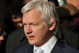 WikiLeaks founder Julian Assange speaks to the waiting media upon leaving London's High Court