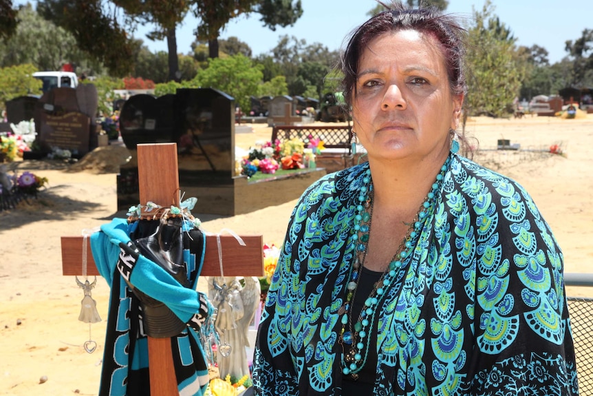 Kathy Narrier next to the grave of her daughter Nicole