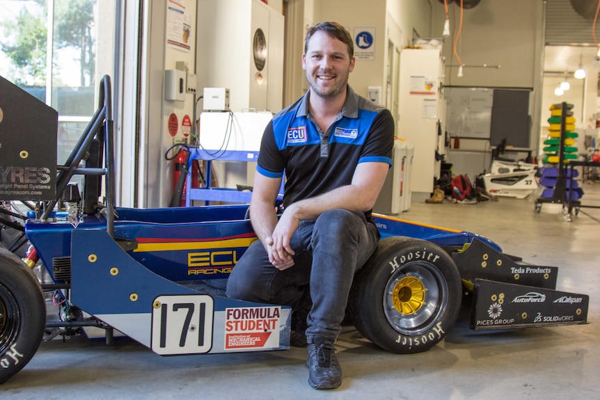 Nathan Van Vugt with the car he and the team produced for Formula Student 2016.