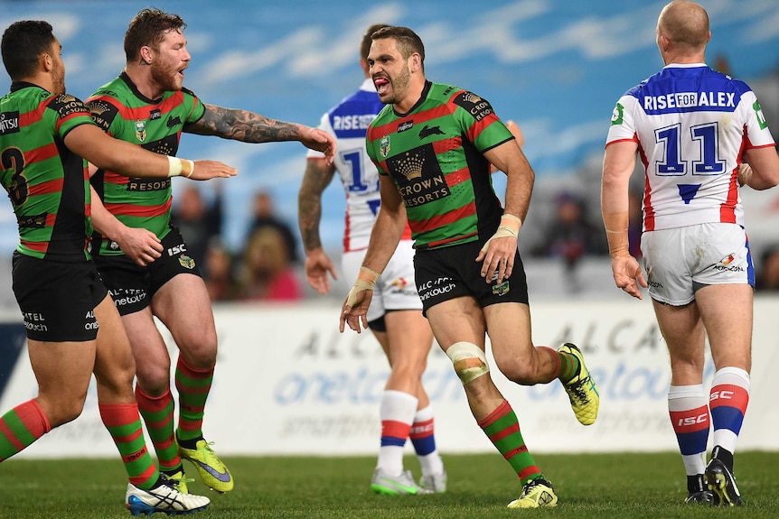 Greg Inglis celebrates his try for South Sydney against Newcastle at the Olympic stadium.