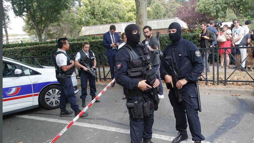 French hooded police officers cordon off the area after a knife attack