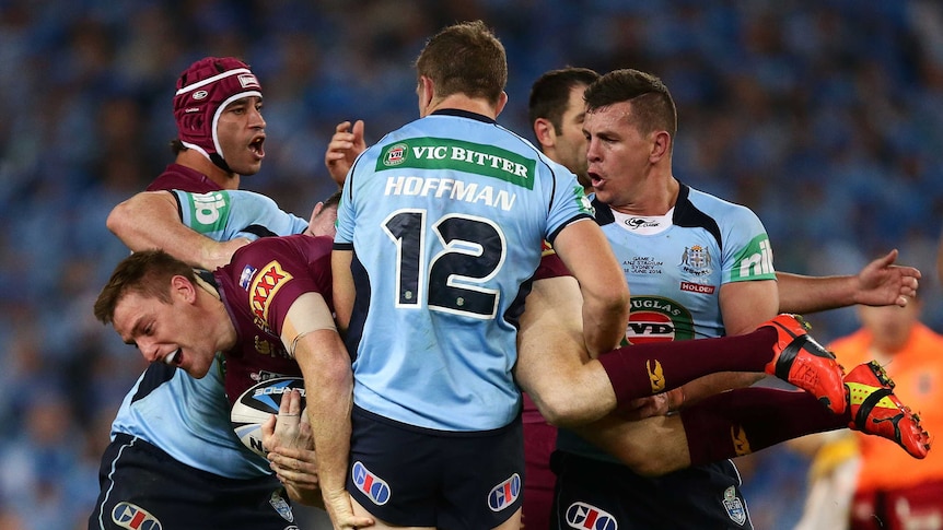 Brent Tate of the Maroons is tackled in Origin game two against New South Wales on June 18, 2014.