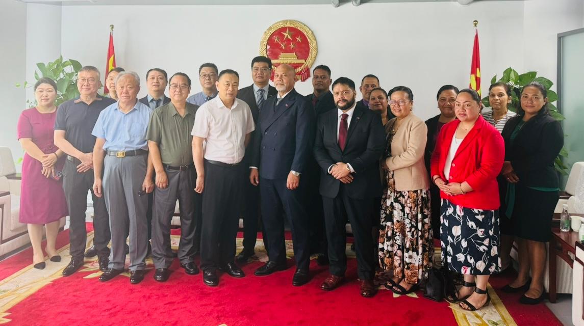 men and women stand in a line. 