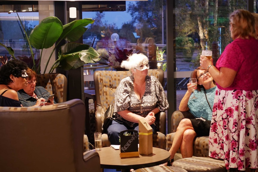 Women sit on comfortable chairs on a night out