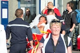 An injured man is carried away on a stretcher from the train station of Arras, northern France, after a suspected terrorist attack on August 21, 2015
