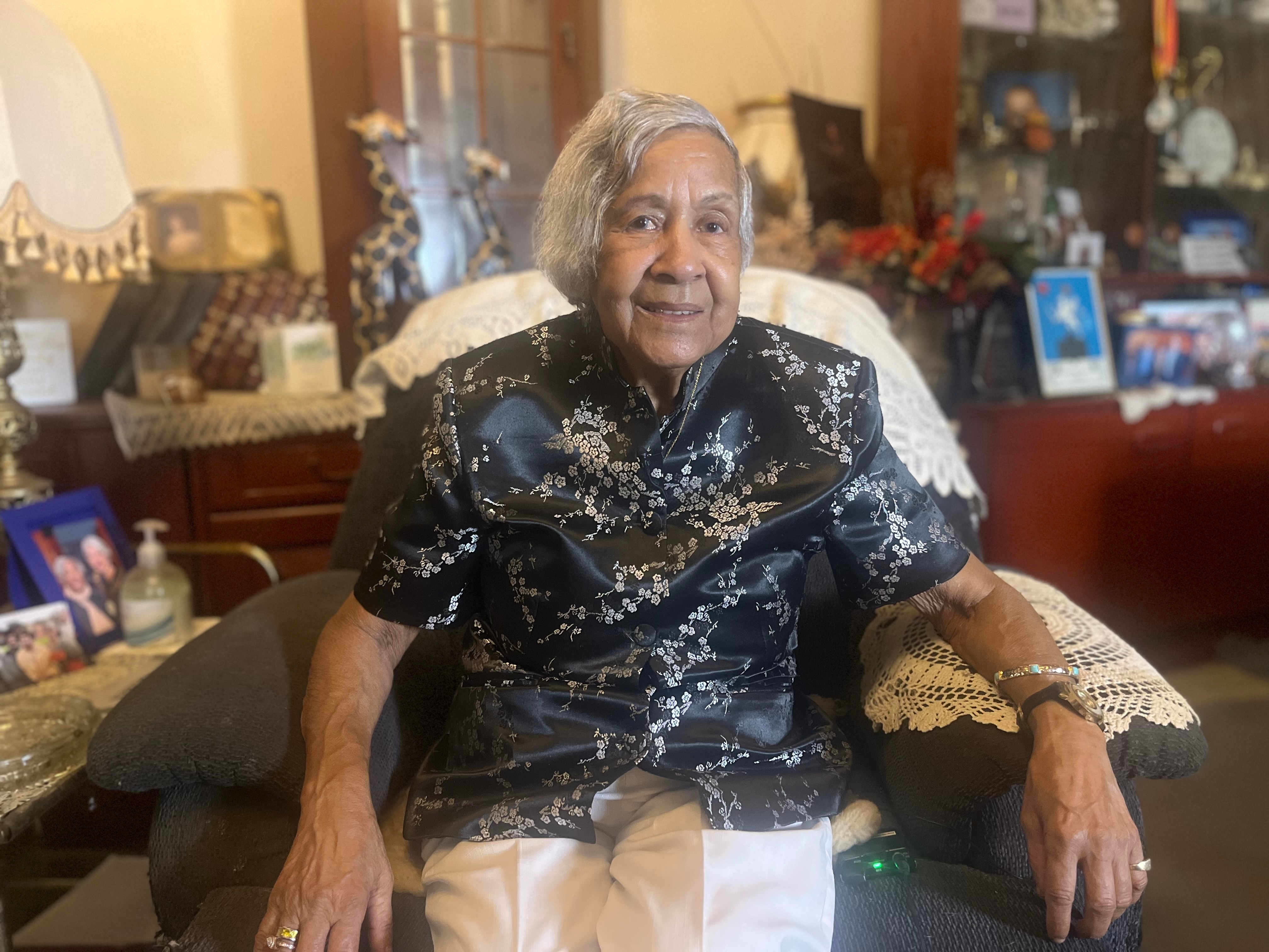 Woman sitting and smiling.