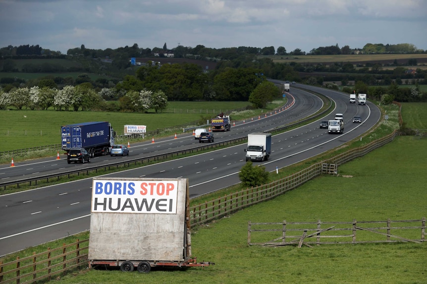 A sign reading "Boris Stop Huawei" is seen next to a motorway