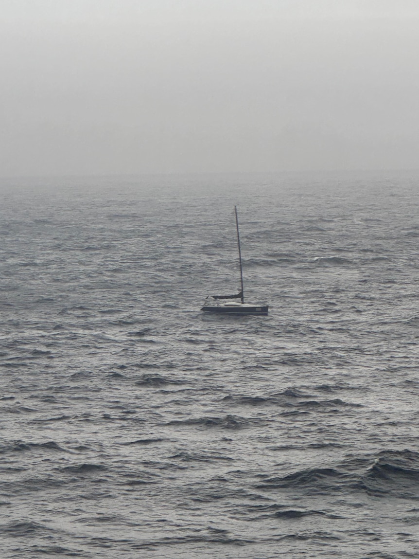 A yacht appearing through fog.