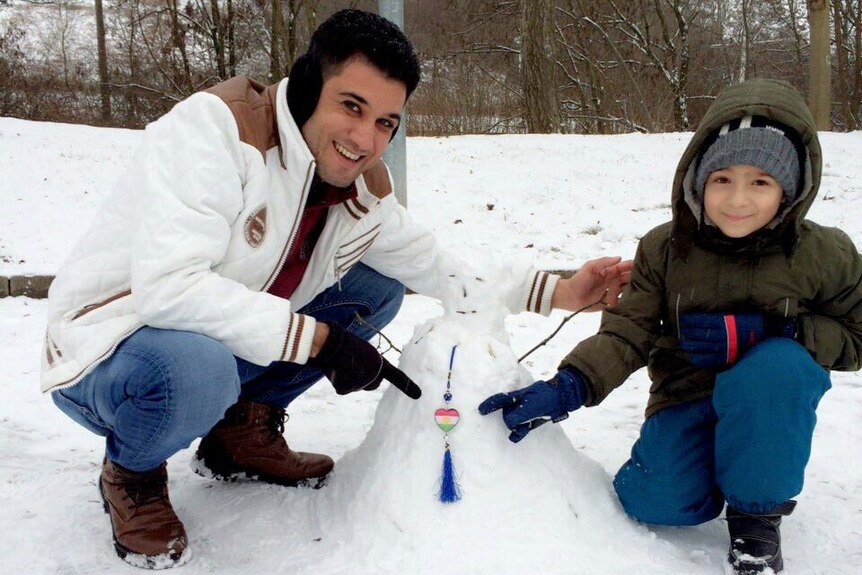 Darya Badr playing in the snow with another Iraqi asylum seeker in Germany