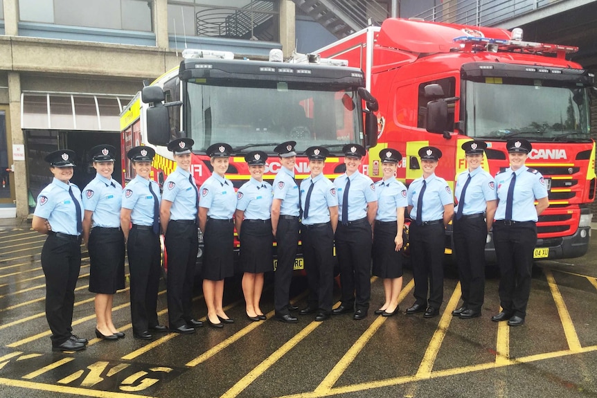 The 12 new female firefighters pose in front of a truck