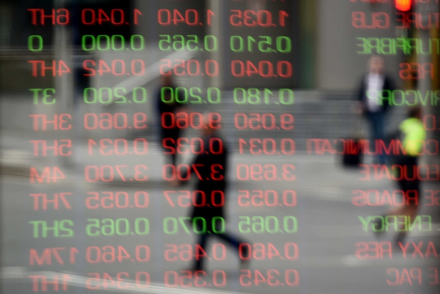 red and green digits from the ASX reflected on a window with people behind it