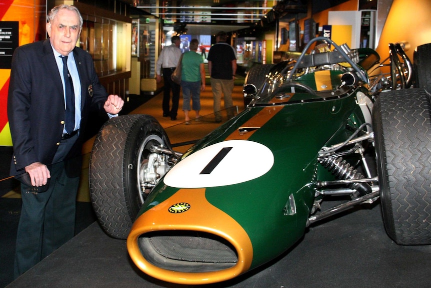 Sir Jack Brabham stands next to his Repco Brabham BT19 when it was on display at the National Sport Museum.