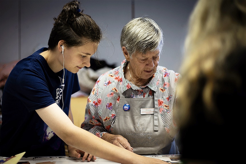 Amelia working with a volunteer in the Op Shop