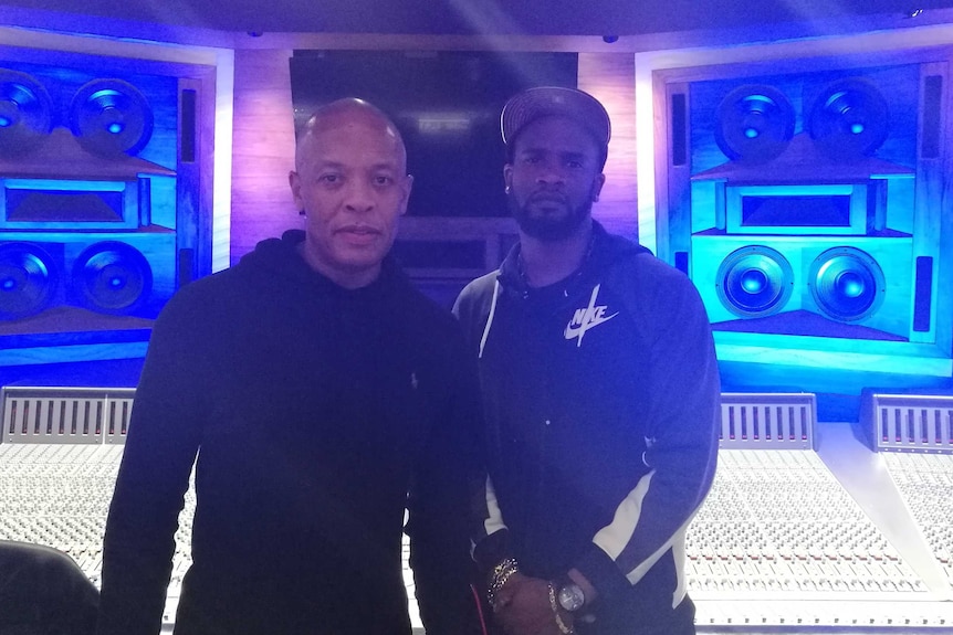 DJ Just Dizle and Dr. Dre, two black men in a studio posing for the camera