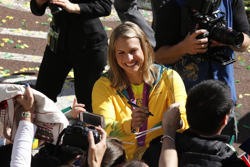 Olympic swimmer Libby Trickett signs autographs at the Olympic Welcome Home Parade in Sydney.