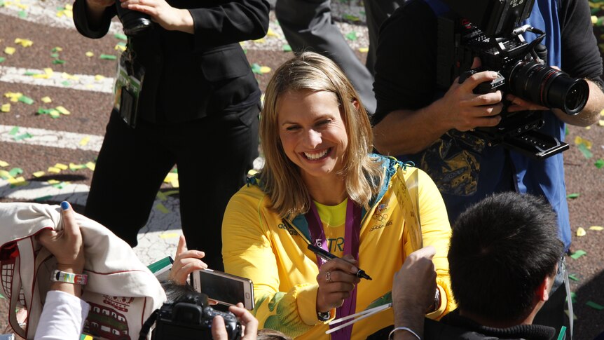 Olympic swimmer Libby Trickett signs autographs at the Olympic Welcome Home Parade in Sydney.