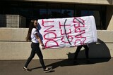 A student carries a mattress at Sydney University to protest sexual assault on campus, August, 2016.