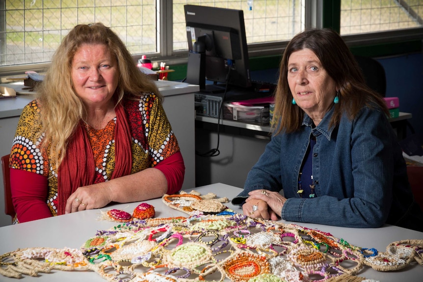 Jo Vinson and Deirdre Heitmeyer sit at a table.