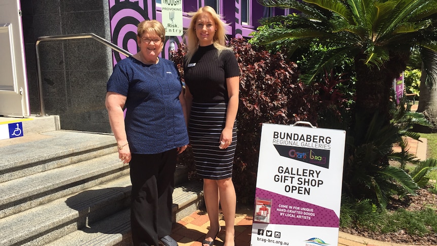 Roana O'Neil and Denise Hodder standing in front of Bundaberg Regional Art Gallery entrance