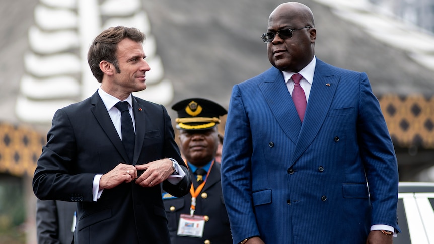 French President Emmanuel Macron and DRC President Felix Tshisekedi walk side by side.