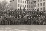 A black and white photo of Shuang Liu and her classmates standing in rows for their graduation photo.