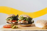 Two burgers on a chopping board with cheese-filled mushrooms, part of 9 mushroom recipes for all occasions.