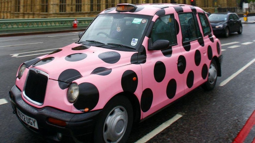 The London taxi painted in Black Caviar's colours sits outside Big Ben.
