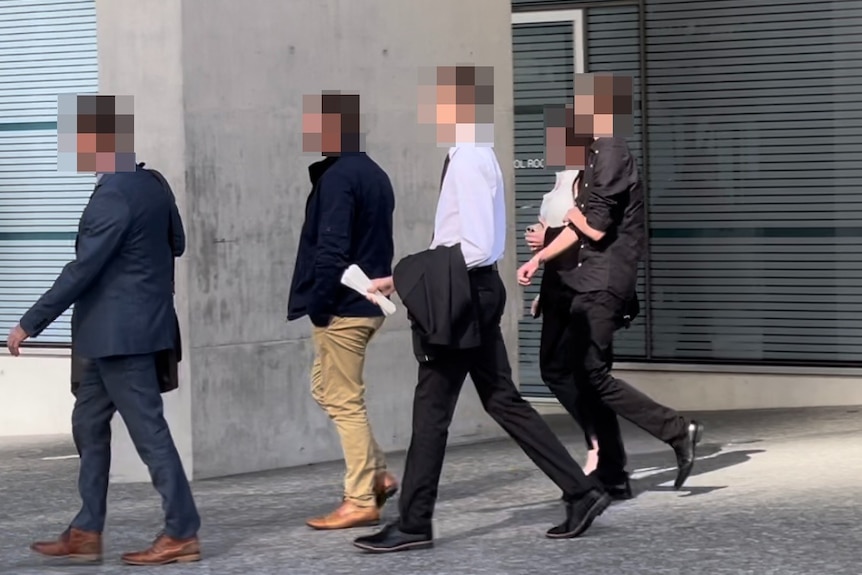 Five people with blurred faces leave the courthouse