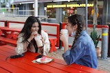 Ghazal Shams (right) and Dorsa Kha (left) sip on drinks at a table in Southbank.