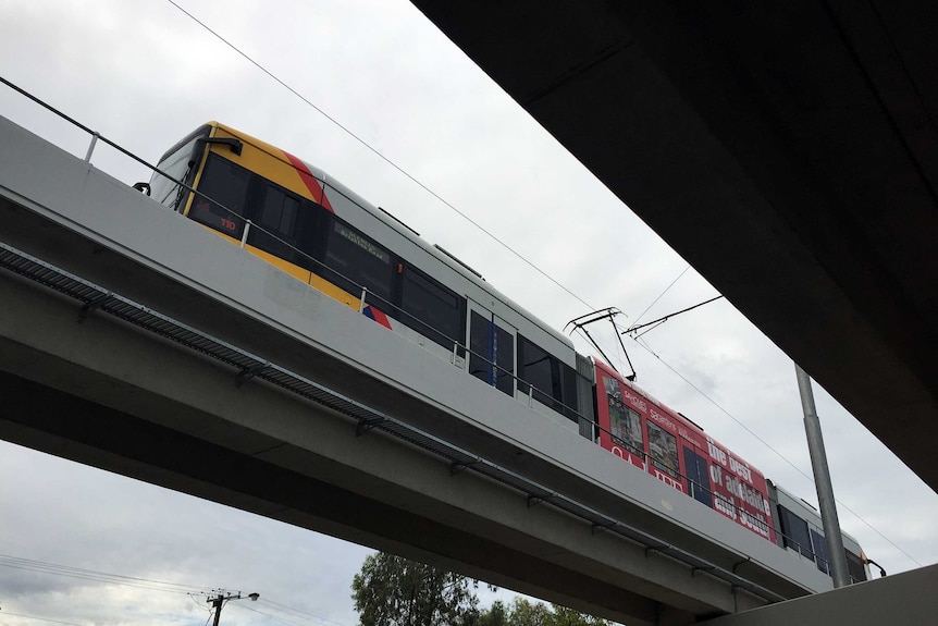 A tram goes over the South Road overpass.