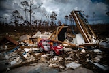 A red toy fire engine sits in the rubble of a house destroyed by Hurricane Dorian.