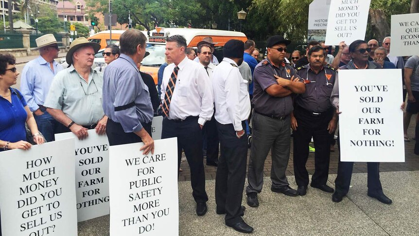 Cab drivers holding placards outside State Parliament in Brisbane
