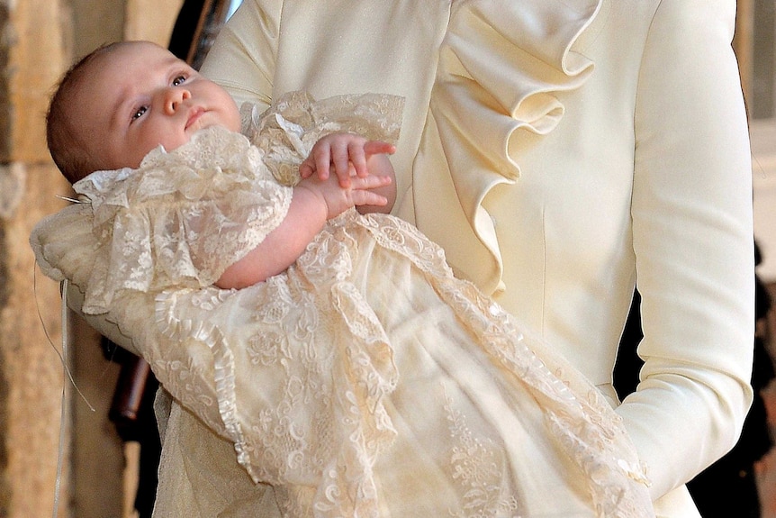 Catherine, Duchess of Cambridge, carries her son Prince George Of Cambridge after his christening.