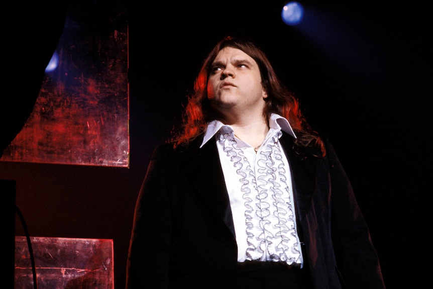 Meat Loaf looks on during a stage performance