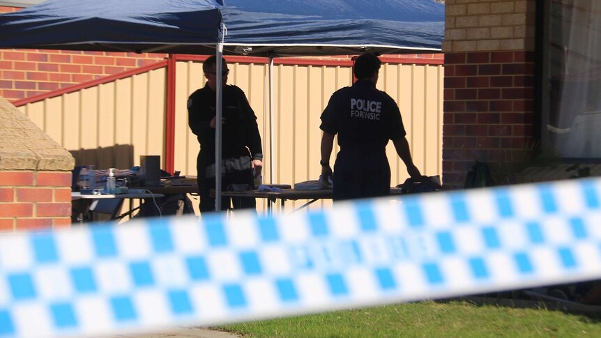 Two WA Police forensic officers stand in the yard of a Midvale house with police tape cordoning off the crime scene.