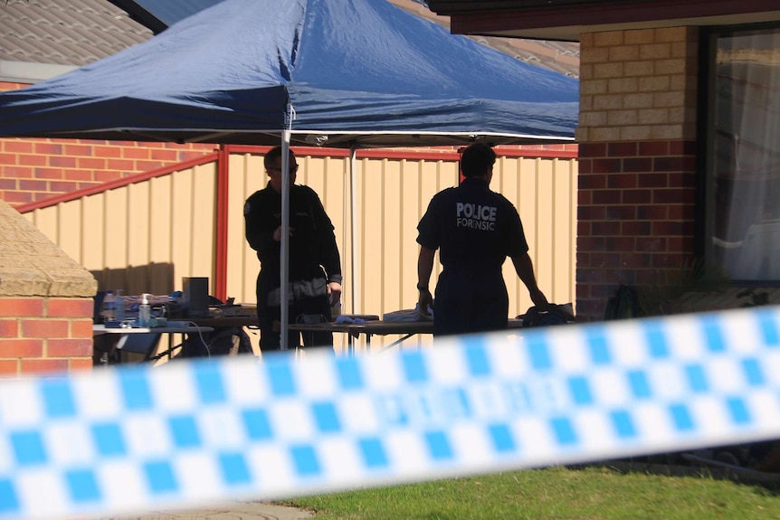 Two WA Police forensic officers stand in the yard of a Midvale house with police tape cordoning off the crime scene.